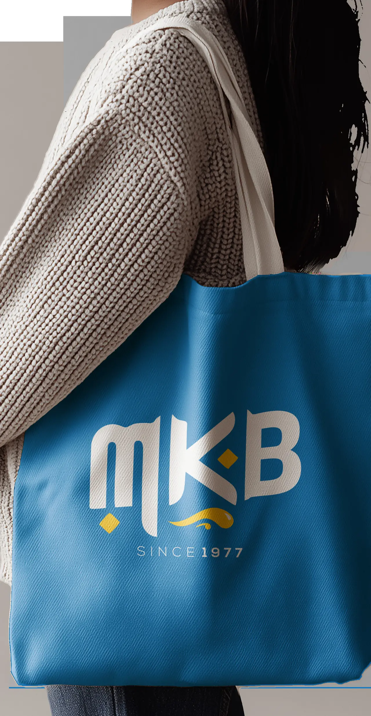 A customer carrying an MKB tote bag out of the shop